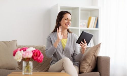 women on a couch, smiling into a table, having a wellness visit at Prescott Medical Aesthetics, a med spa in Prescott, Arizona
