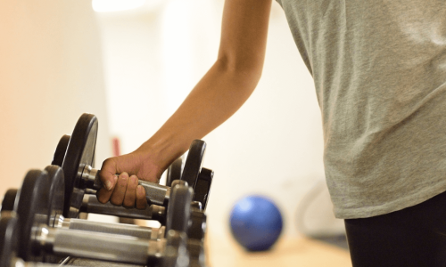 Women at a weight rack depicting how to get over a weight loss plateau